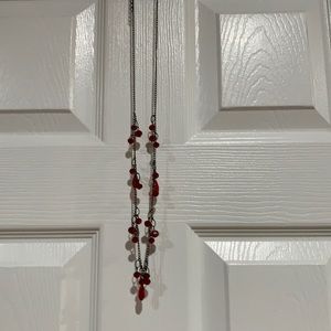Long necklace with ruby colored jewels